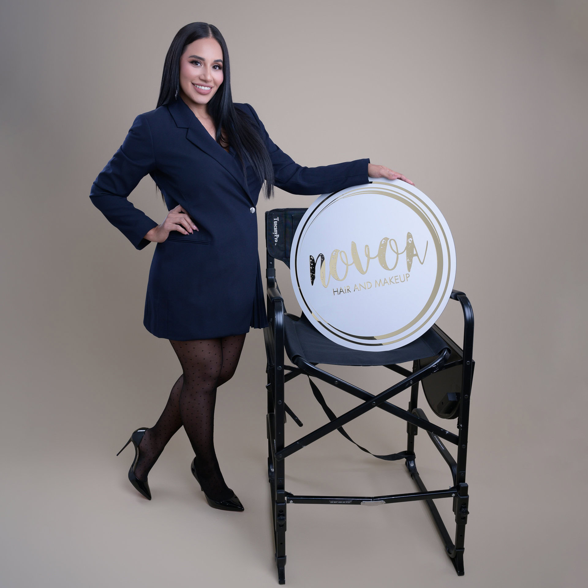 Make up artist holding her logo sign